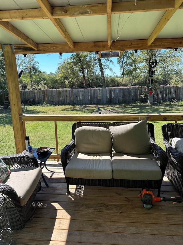 wooden terrace with an outdoor hangout area and a lawn