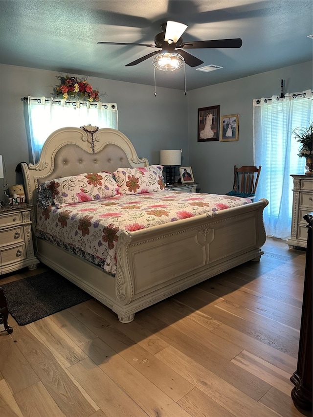 bedroom with light wood-type flooring and ceiling fan