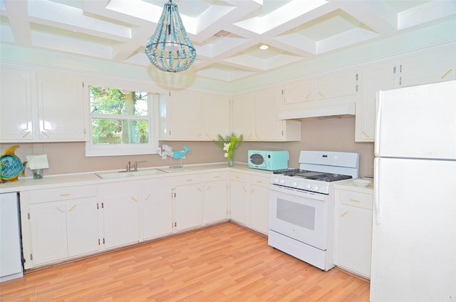 kitchen with white appliances, white cabinets, sink, and hanging light fixtures