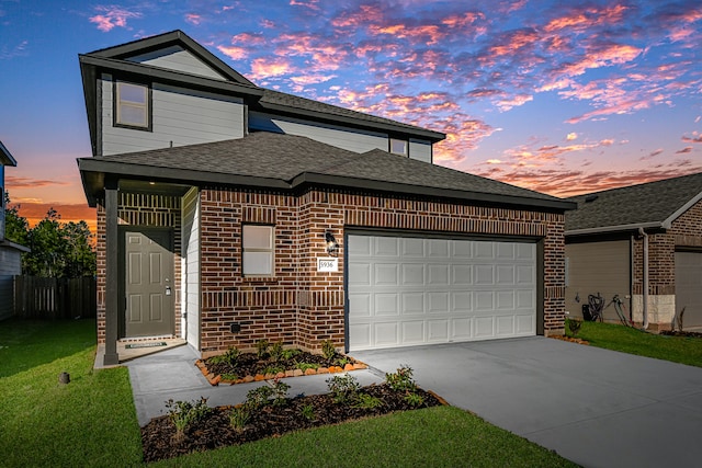 view of front of home featuring a lawn and a garage