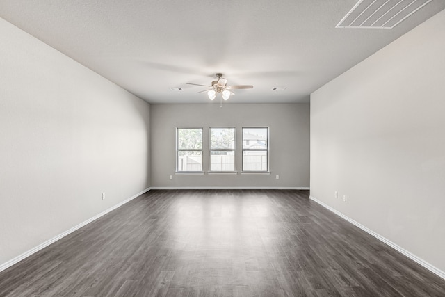 spare room featuring dark hardwood / wood-style floors and ceiling fan