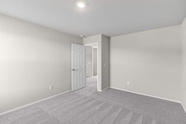 spare room featuring light colored carpet