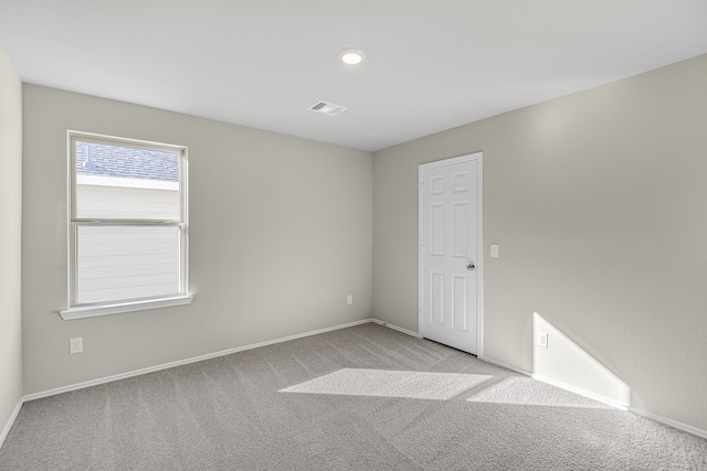 unfurnished room with light carpet