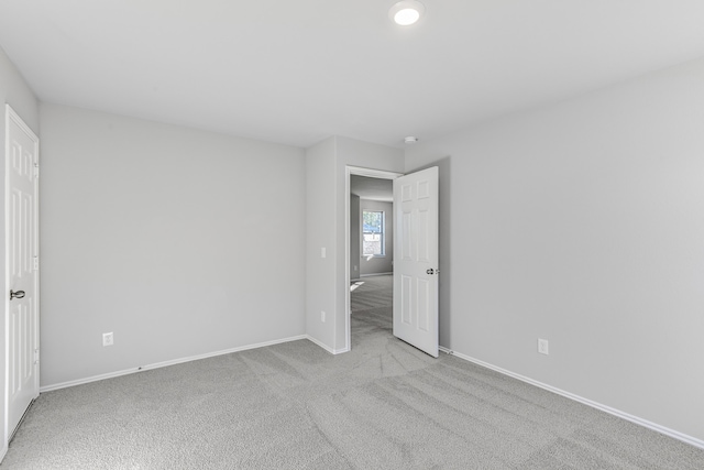 unfurnished bedroom with light colored carpet