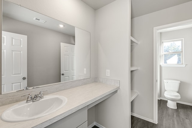 bathroom featuring hardwood / wood-style flooring, vanity, and toilet