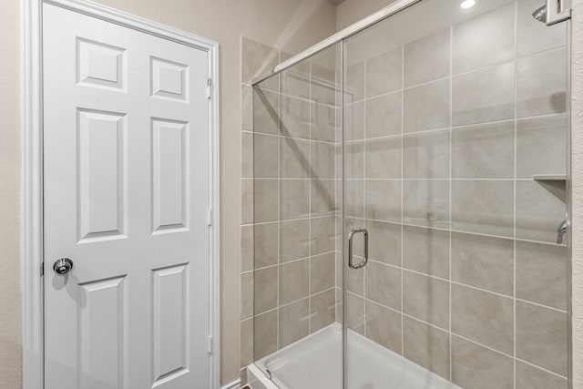 bathroom with a shower with shower door