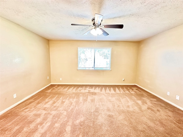 spare room with ceiling fan, carpet floors, and a textured ceiling