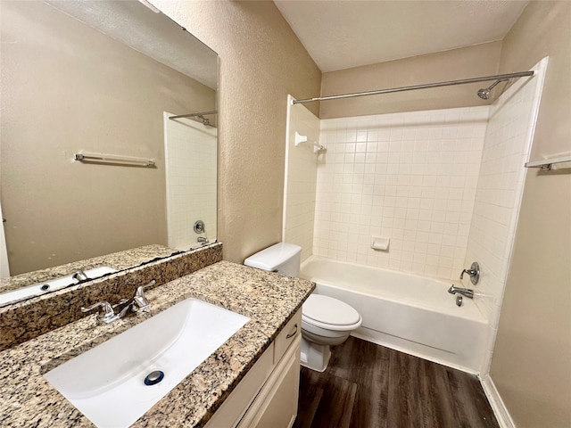 full bathroom with wood-type flooring, vanity, toilet, and tiled shower / bath combo