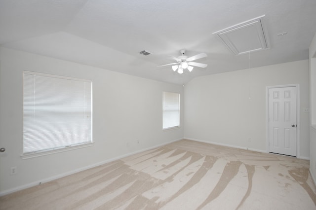 carpeted spare room with vaulted ceiling and ceiling fan