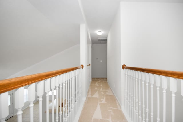 hall with light colored carpet