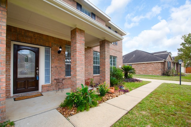 property entrance featuring a lawn