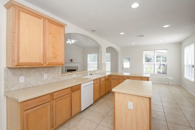 kitchen with a wealth of natural light, dishwasher, kitchen peninsula, and ceiling fan