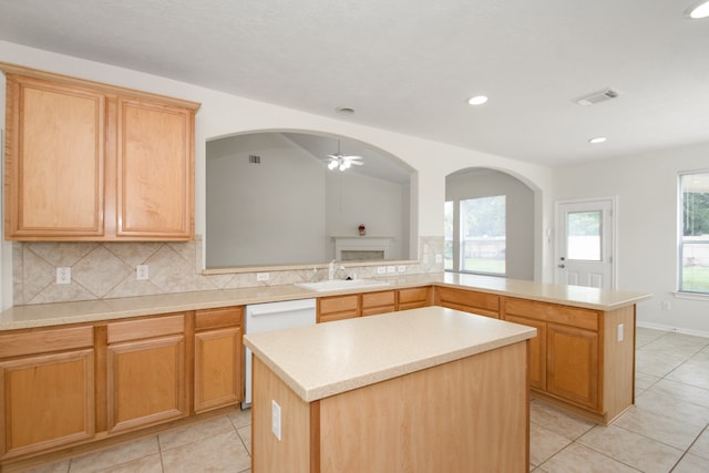 kitchen featuring ceiling fan, a center island, a healthy amount of sunlight, and sink