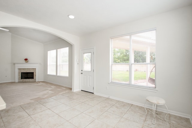 foyer featuring a tile fireplace and light tile patterned floors