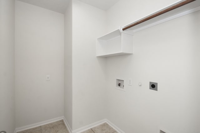 clothes washing area featuring washer hookup, hookup for a gas dryer, electric dryer hookup, and light tile patterned flooring