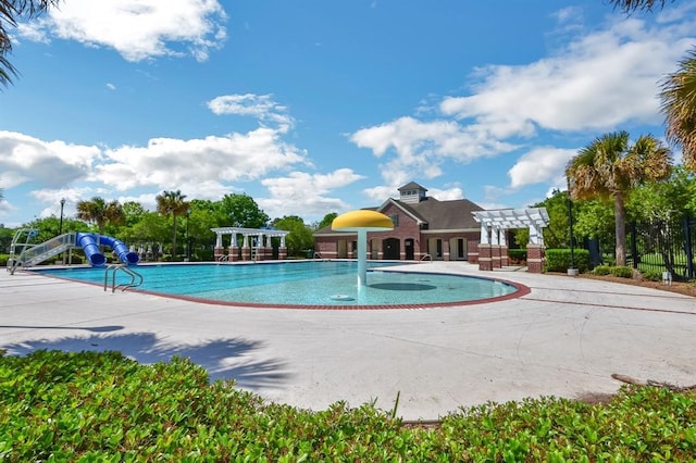 view of swimming pool featuring a patio and a water slide