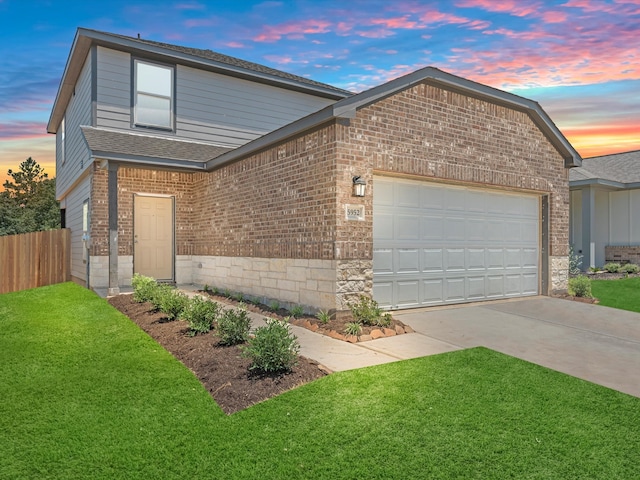 view of front facade featuring a lawn and a garage