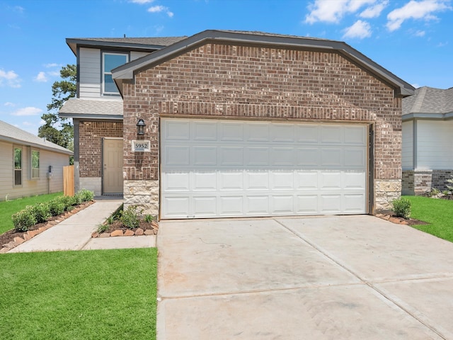 front facade featuring a garage and a front lawn