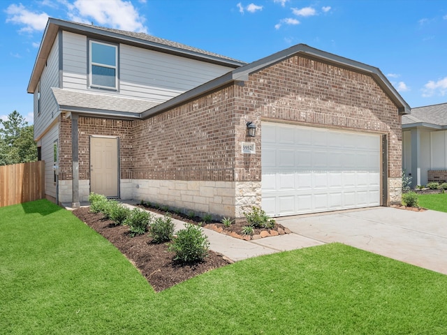 front of property with a garage and a front lawn