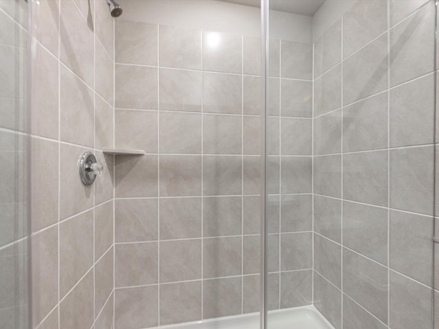 bathroom with tiled shower