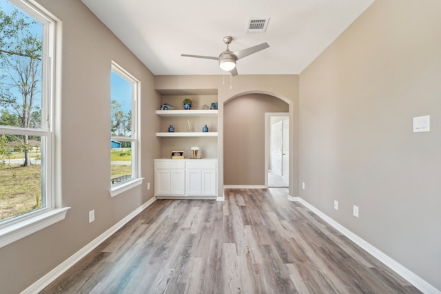 interior space featuring light hardwood / wood-style floors, ceiling fan, and built in features