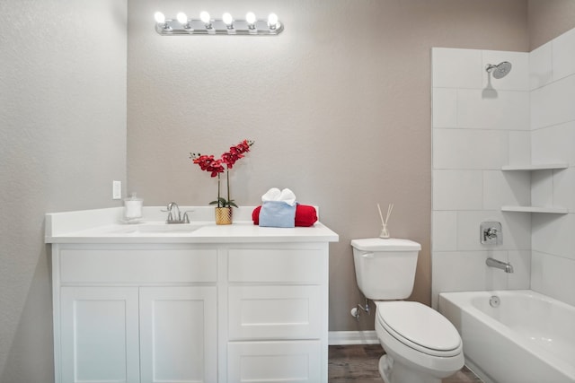 full bathroom with vanity, toilet, washtub / shower combination, and hardwood / wood-style flooring