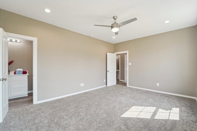 empty room featuring ceiling fan and carpet