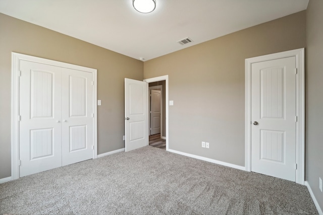 unfurnished bedroom featuring carpet and a closet