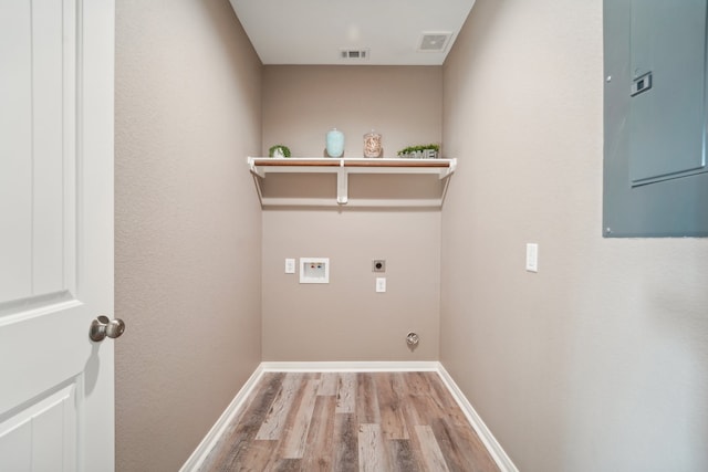 washroom featuring washer hookup, hookup for an electric dryer, and light hardwood / wood-style floors