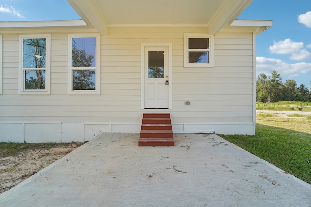 property entrance featuring a patio