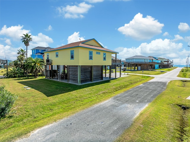 view of side of property with a lawn and a carport