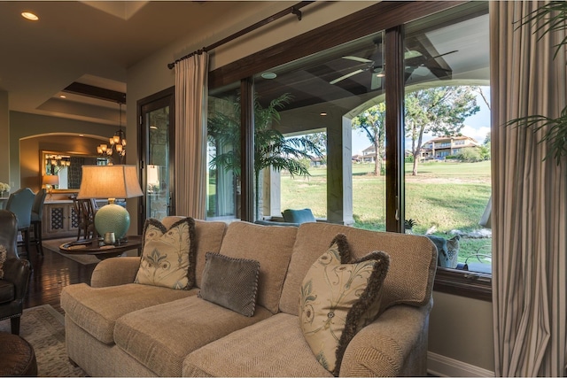 interior space featuring ceiling fan with notable chandelier