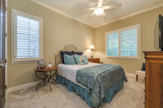 bedroom featuring crown molding, multiple windows, ceiling fan, and light carpet