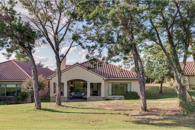 rear view of property with a yard