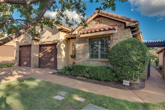 mediterranean / spanish home featuring a front lawn