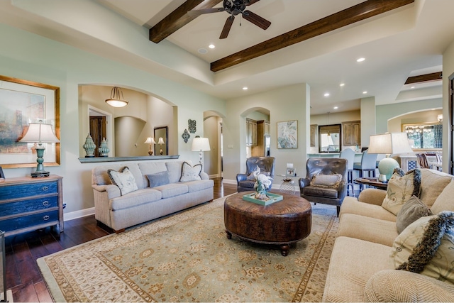 living room with ceiling fan, beam ceiling, and dark hardwood / wood-style flooring