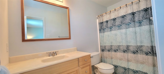 bathroom featuring vanity, toilet, and curtained shower