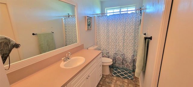 bathroom featuring vanity, toilet, and a shower with shower curtain