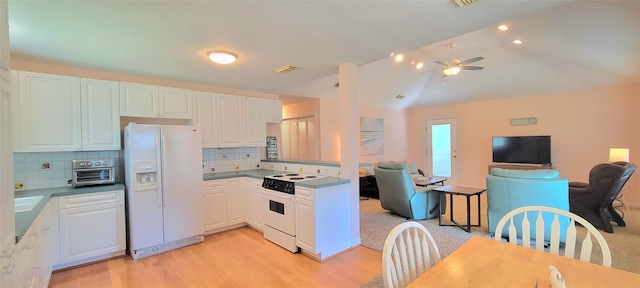 kitchen with white cabinets, light hardwood / wood-style flooring, white appliances, and decorative backsplash