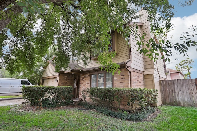 view of front of house with a garage and a front lawn