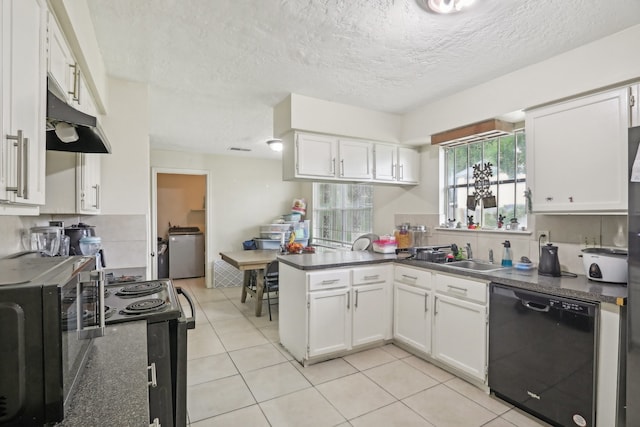 kitchen featuring dishwasher, light tile patterned floors, sink, and white cabinets