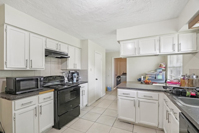 kitchen featuring white cabinets, a textured ceiling, appliances with stainless steel finishes, and light tile patterned floors