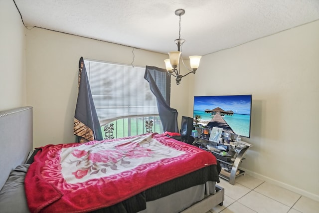 tiled bedroom with a textured ceiling and a chandelier