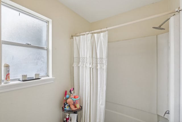 bathroom with shower / bath combo with shower curtain