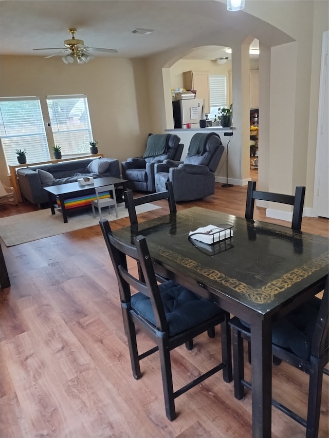 dining area with ceiling fan and hardwood / wood-style floors