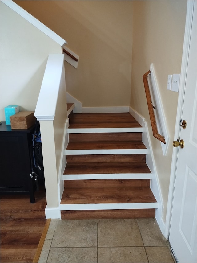 stairs featuring hardwood / wood-style flooring