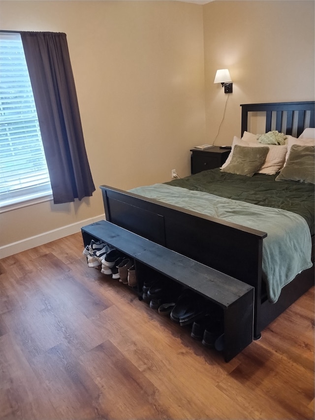 bedroom with hardwood / wood-style flooring