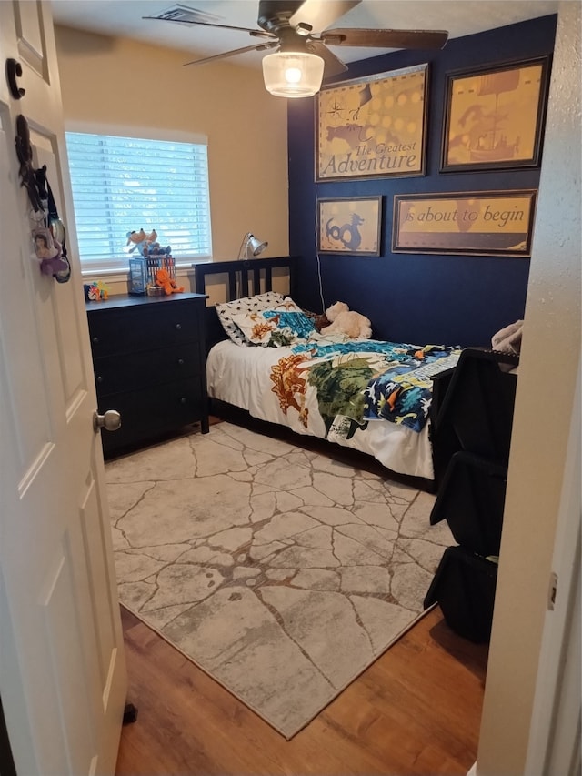 bedroom featuring ceiling fan and hardwood / wood-style flooring