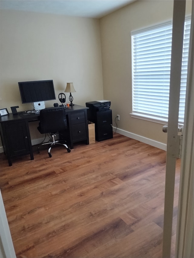 home office with hardwood / wood-style floors