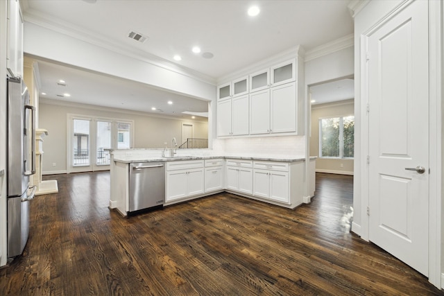 kitchen featuring a wealth of natural light, dark wood-type flooring, stainless steel appliances, and white cabinets